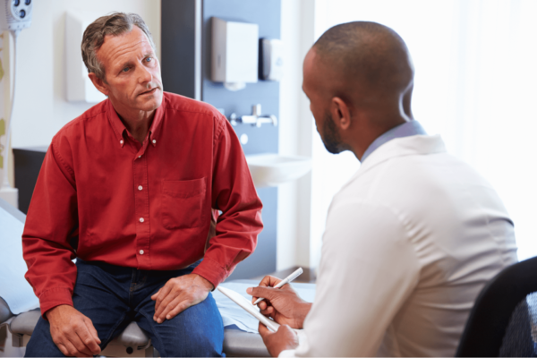 Man Consulting Doctor About Elective Procedure During Covid-19 Pandemic