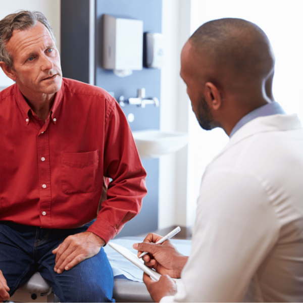 Man Consulting Doctor About Elective Procedure During Covid-19 Pandemic