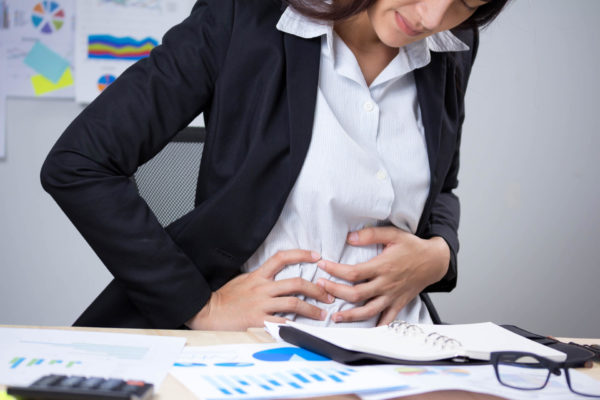 Woman Suffering From IBD Holding Her Stomach