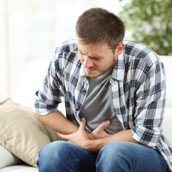 Man In Living Room Has Stomach Pain From Gastritis